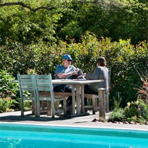 Two people meeting by the pool at Westerbeke Ranch